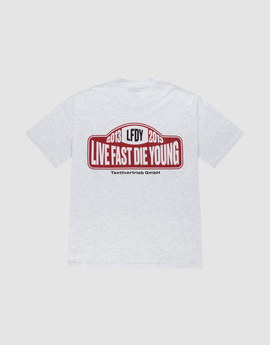 The Live Fast 2013 Tee by LIVE FAST DIE YOUNG is a light gray regular fit cotton t-shirt with a bold red and white backprint: “2013 LFDY 2013 LIVE FAST DIE YOUNG” above smaller Textilvertieb GmbH text. | plain