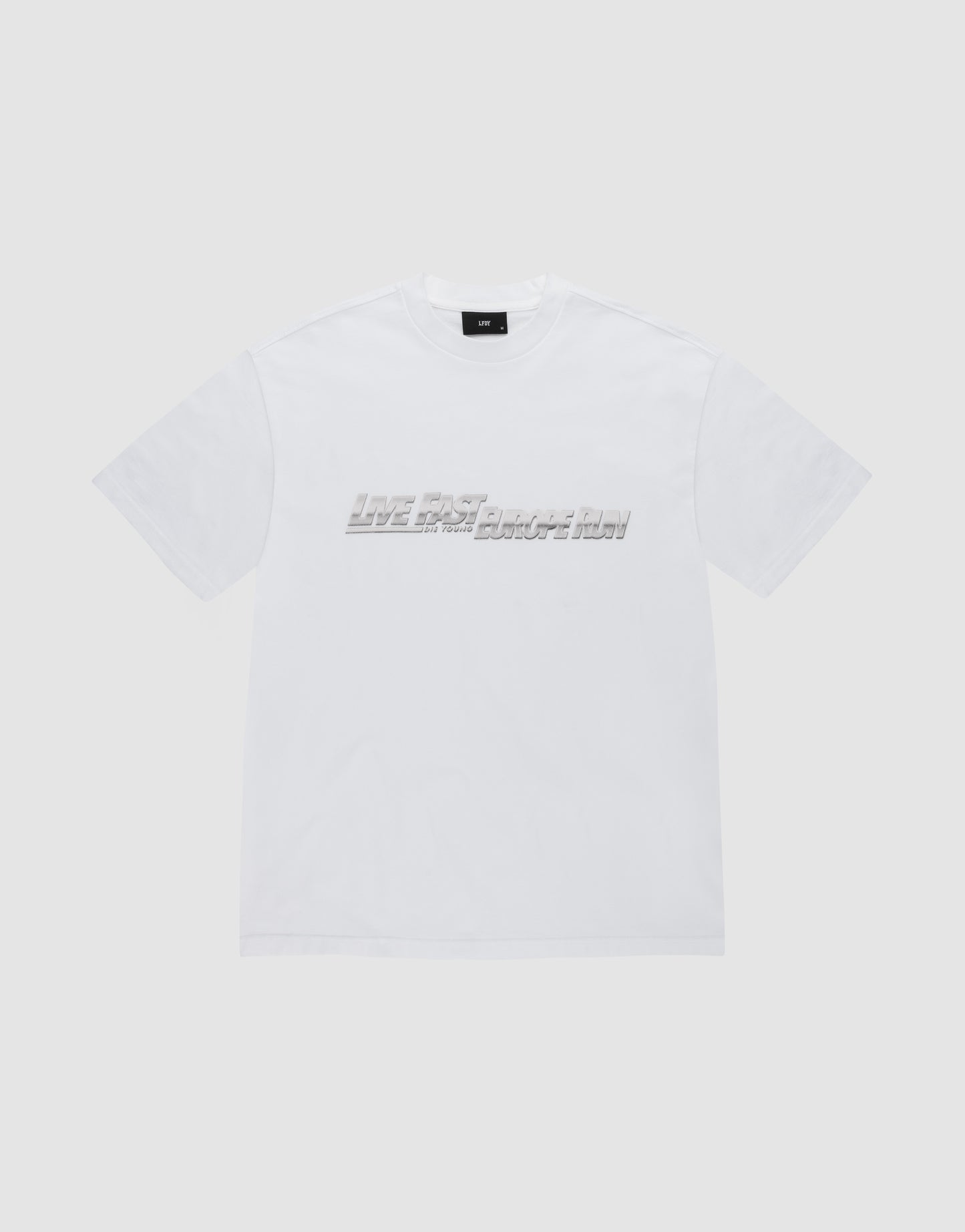 The LFDY Europe Run Tee by LIVE FAST DIE YOUNG is a plain white, short-sleeve t-shirt made of 100% Baumwolle, featuring "LIVE FAST BREAK IT SLOW" in gray blocky letters across the chest on a light gray background.