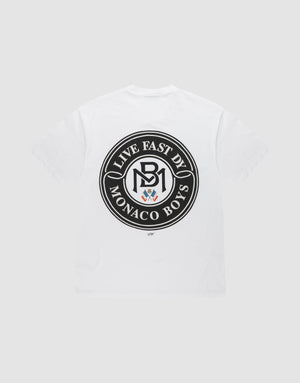 The LFDY Monaco Boys Tee by LIVE FAST DIE YOUNG is a white Oversize Fit T-shirt with a black circular back emblem reading "LIVE FAST DIE MONACO BOYS" around an MB logo and crest. Made from 100% cotton for comfort. | plain
