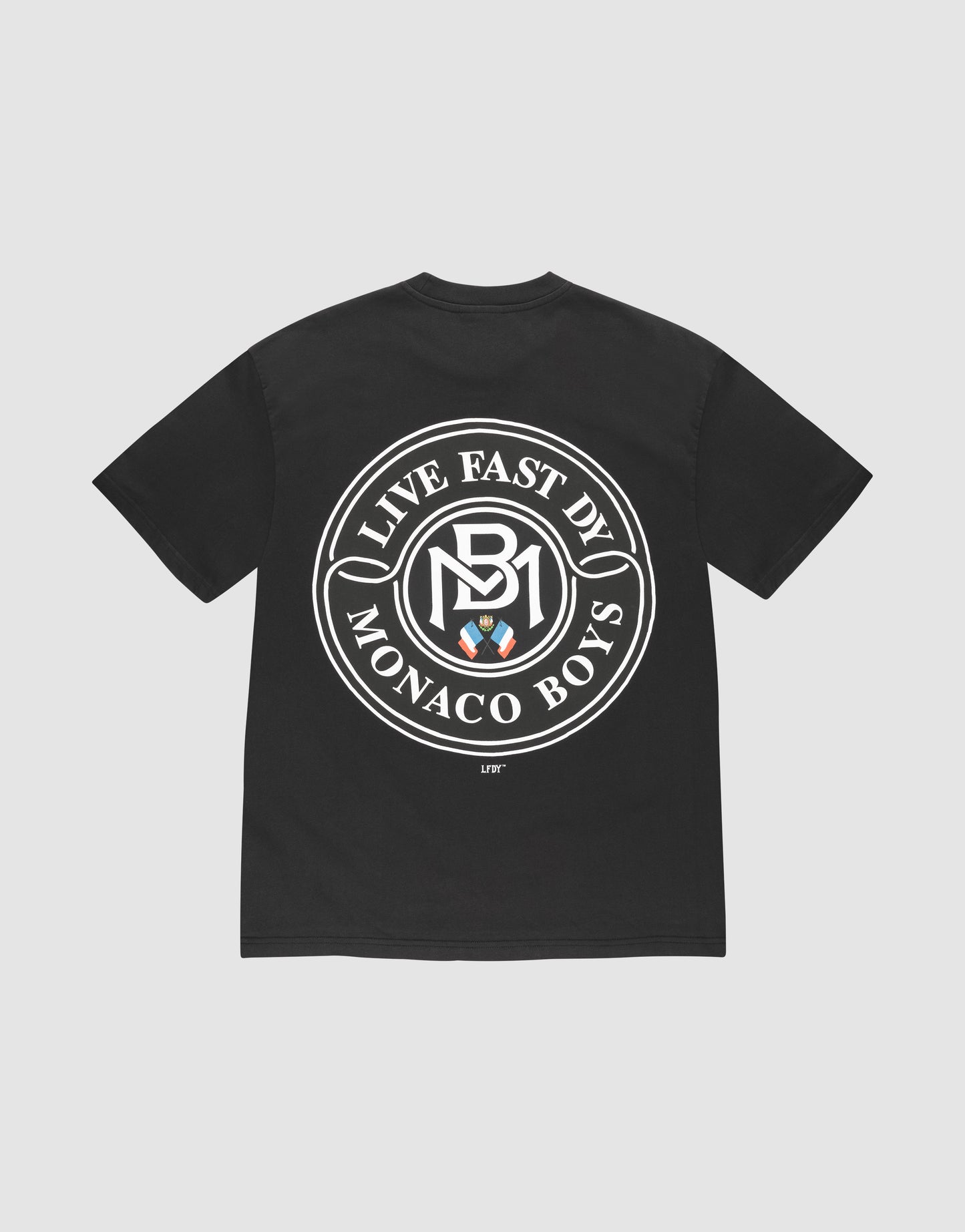 The LFDY Monaco Boys Tee by LIVE FAST DIE YOUNG features an oversize black fit, a bold white circular logo with "LIVE EAST DY MONACO BOYS" and three shields on the back, "LIFT" near the hem, and is made of 100% cotton. | plain
