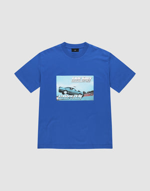 The LFDY Crash Kid Tee by LIVE FAST DIE YOUNG is a blue, regular fit shirt in 100% cotton, with a car mid-jump frontprint and bold white "LIVE FAST" above and "DRIVE SLOW" below. | plain