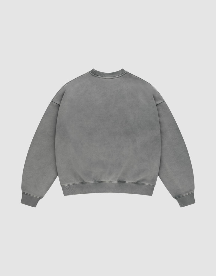 The LIVE FAST DIE YOUNG Live Fast Europe Run Sweater, a plain grey oversize-fit crewneck with long sleeves, is shown laid flat with the back facing up against a light background.