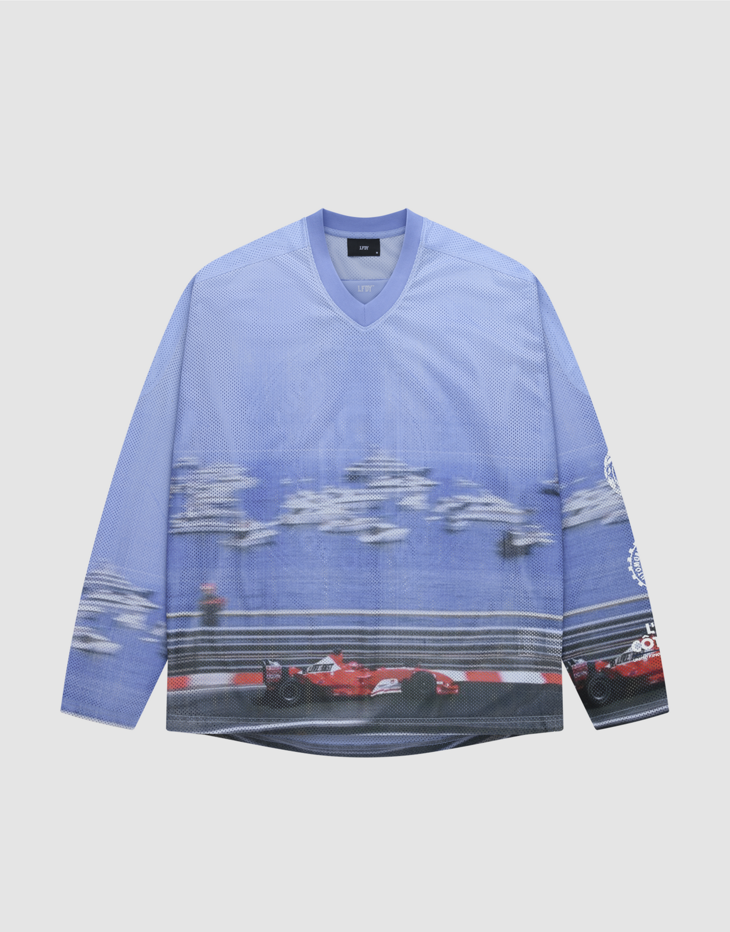 The LFDY Yacht Jersey by LIVE FAST DIE YOUNG is a long-sleeved, blue mesh top with an oversize fit, showcasing a vivid red Formula 1 car print, blurred cars in the background, white sleeve graphics, and made from 100% polyester.