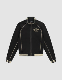 The Live Fast Tracksuit Jacket by LIVE FAST DIE YOUNG is a black jacket with cream piping, striped cuffs and hem, and a Chainstitch Live Fast Rallye logo on the left chest. Made from Baumwolle Polyester with a regular fit, it has a full zip and stand-up collar. | plain