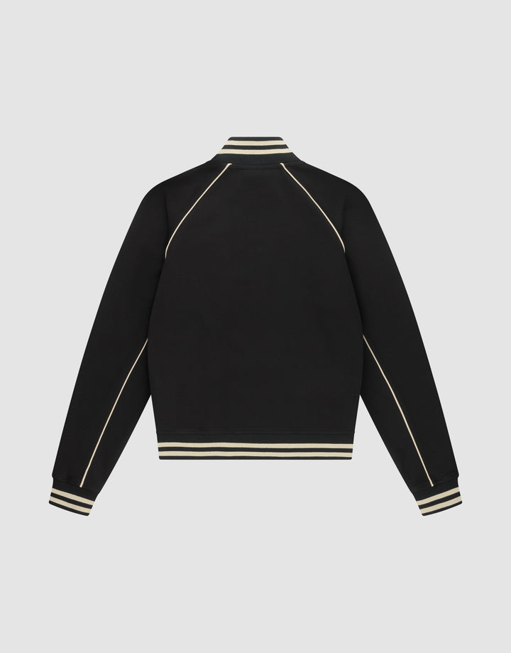 The Live Fast Tracksuit Jacket by LIVE FAST DIE YOUNG is a black varsity-style piece with cream stripes on the ribbed collar, cuffs, and hem, plus cream piping on the sleeves and shoulders. Made from Baumwolle Polyester in a regular fit.