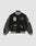The LIVE FAST DIE YOUNG LFDY x Schott NYC Varsity Jacket is a limited edition black jacket with cream accents, leather sleeves, embroidered patches and text, plus striped cuffs, collar, and hem.