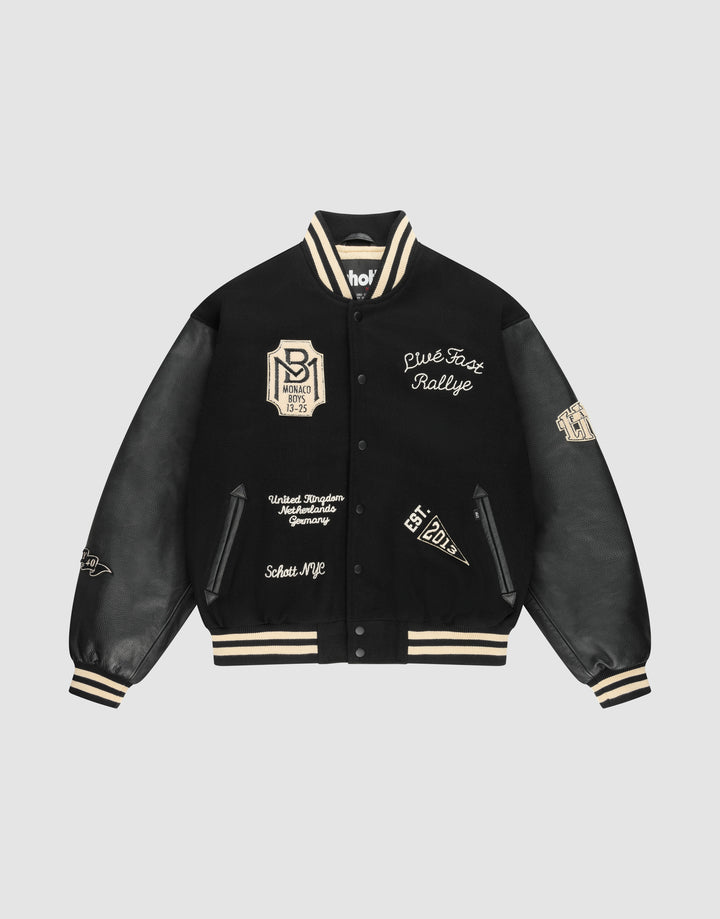 The LIVE FAST DIE YOUNG LFDY x Schott NYC Varsity Jacket is a limited edition black jacket with cream accents, leather sleeves, embroidered patches and text, plus striped cuffs, collar, and hem. | plain