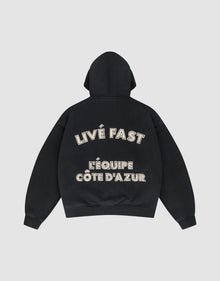 The LFDY L'Équipe Hooded Zip by LIVE FAST DIE YOUNG is a black oversize hoodie with LIVE FAST and LÉQUIPE CÔTE DAZUR in bold white lettering on the back, plus a soft waffle lining for extra comfort. | plain