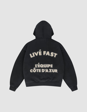 The LFDY L'Équipe Hooded Zip by LIVE FAST DIE YOUNG is a black oversize hoodie with LIVE FAST and LÉQUIPE CÔTE DAZUR in bold white lettering on the back, plus a soft waffle lining for extra comfort. | plain