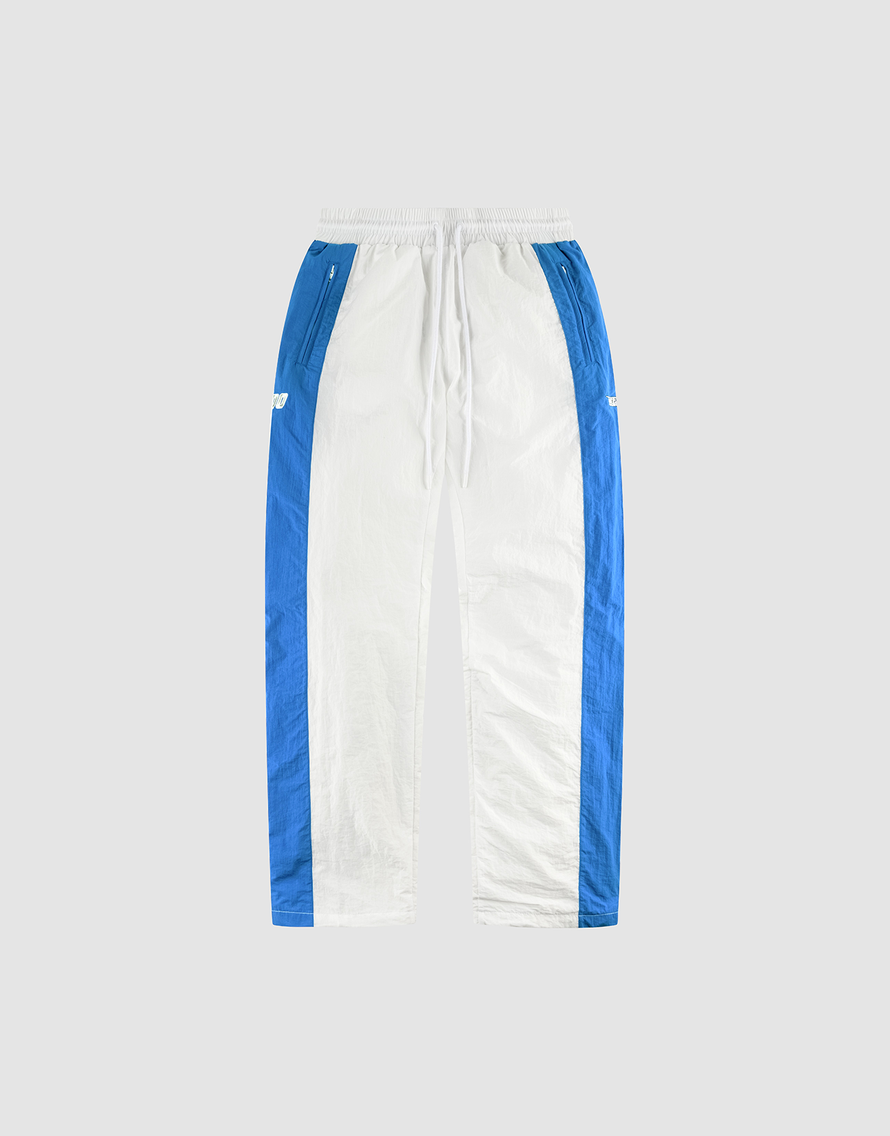 The LFDY Trackpants 3000 by LIVE FAST DIE YOUNG feature white fabric with blue side panels, a comfy elastic waistband and drawstring, zippered side pockets, and a relaxed wide fit. Shown on a light gray background. | plain