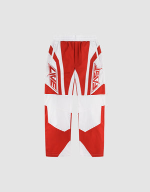 The LFDY Cross Pants by LIVE FAST DIE YOUNG are oversize-fit, wide-leg athletic pants in red and white with bold geometric patterns, “LIVE” and “FAST” lettering on each thigh, made from Baumwolle, all set on a light gray background. | plain