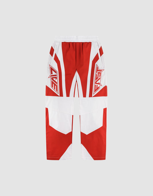 The LFDY Cross Pants by LIVE FAST DIE YOUNG are oversize-fit, wide-leg athletic pants in red and white with bold geometric patterns, “LIVE” and “FAST” lettering on each thigh, made from Baumwolle, all set on a light gray background. | plain