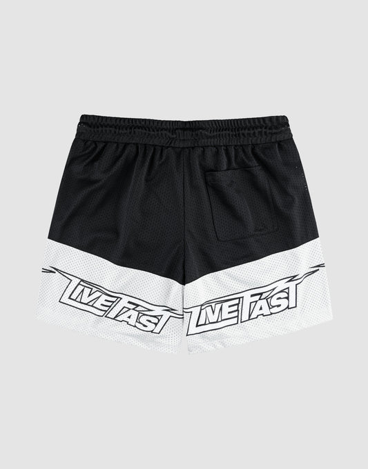 The LFDY Racing Mesh Shorts by LIVE FAST DIE YOUNG are black and white athletic shorts with a wide elastic waistband, back pocket, and large "LIVE FAST" prints on the lower white section of both legs. Background is plain light gray.