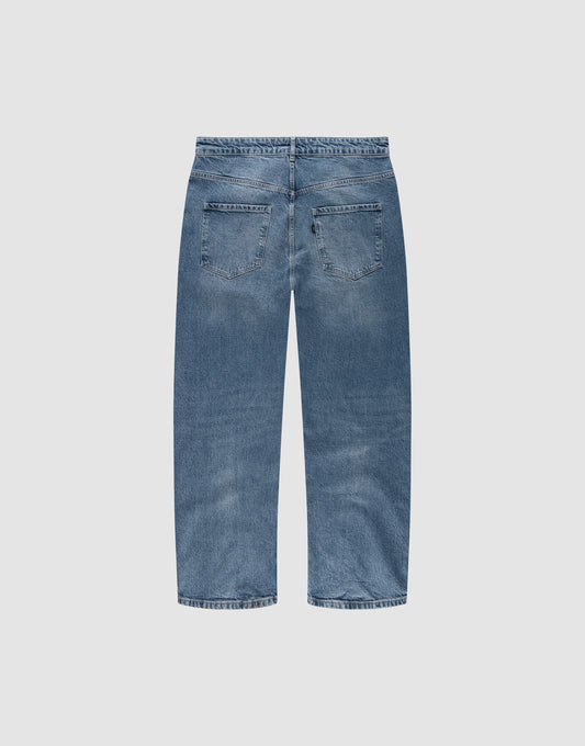 Back view of the LFDY Tire Tracks Denim by LIVE FAST DIE YOUNG in blue, featuring a baggy fit, straight leg, two back pockets, subtle fading on seat and thighs. Crafted from 100% cotton and displayed on a plain white background.