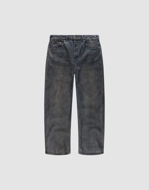 The LFDY Coated Baggy Denim by LIVE FAST DIE YOUNG features wide legs, a baggy fit, faded black 100% Baumwolle fabric, distressed detailing, and subtle paint splatters, shown against a plain white background. | plain