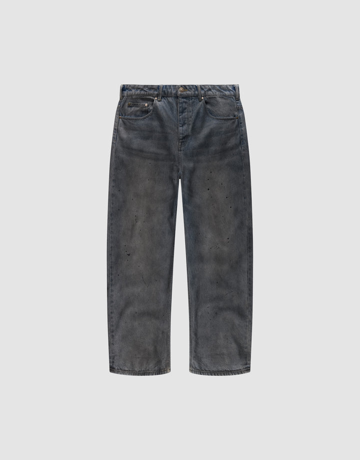 The LFDY Coated Baggy Denim by LIVE FAST DIE YOUNG features wide legs, a baggy fit, faded black 100% Baumwolle fabric, distressed detailing, and subtle paint splatters, shown against a plain white background. | plain