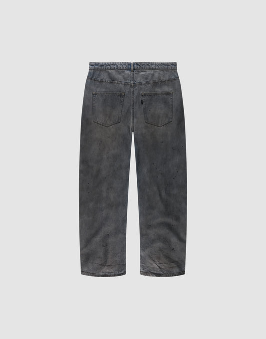 Back view of the LIVE FAST DIE YOUNG LFDY Coated Baggy Denim in faded black, made from 100% Baumwolle, featuring a baggy fit, two back pockets, and subtle paint splatters on a plain light gray background.