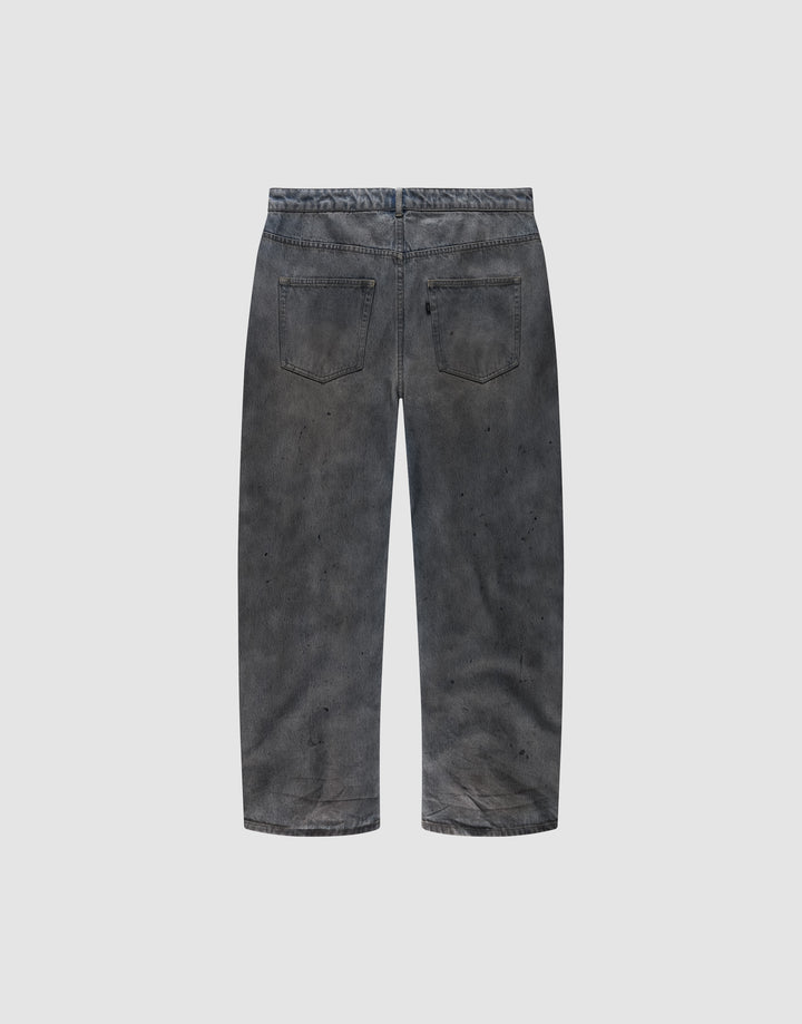Back view of the LIVE FAST DIE YOUNG LFDY Coated Baggy Denim in faded black, made from 100% Baumwolle, featuring a baggy fit, two back pockets, and subtle paint splatters on a plain light gray background.