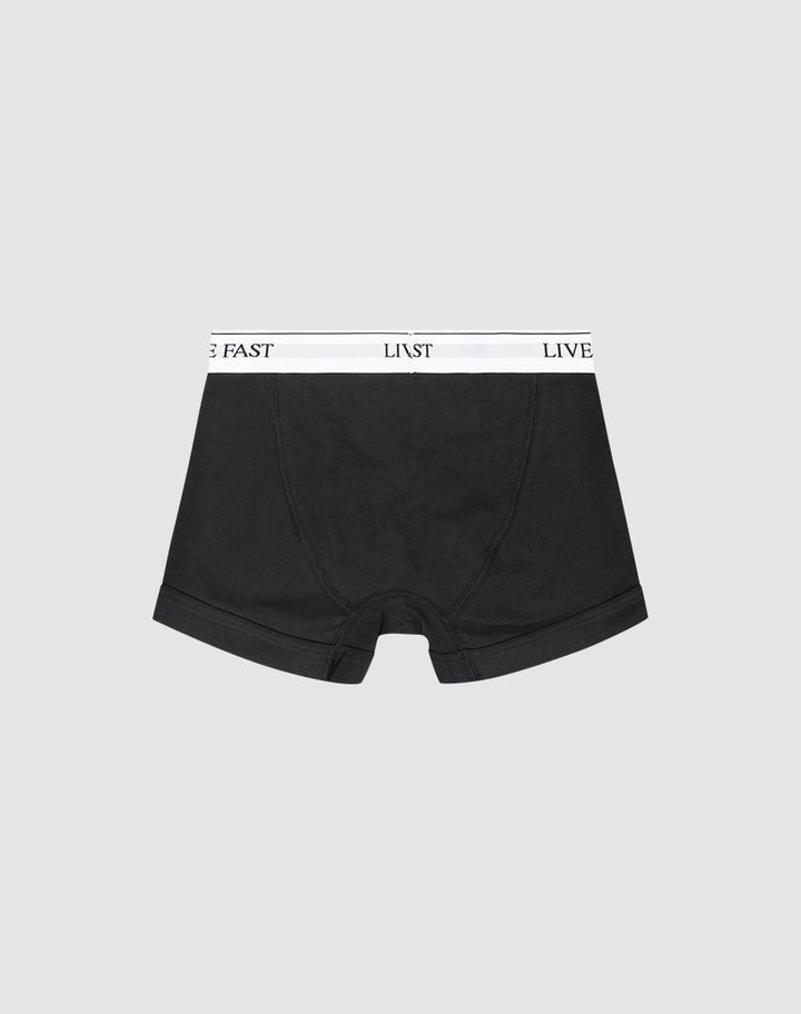 LIVE FAST DIE YOUNG Live Fast Trunks (2 Pack): Black regular-fit boxer briefs with a white waistband featuring LIVE FAST in black text, shown on a light gray background.