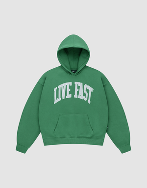 The Live Fast College Hooded by LIVE FAST DIE YOUNG is an oversize green hoodie with a white "LIVE FAST" front print, front pocket, shown on a plain light gray background. | plain