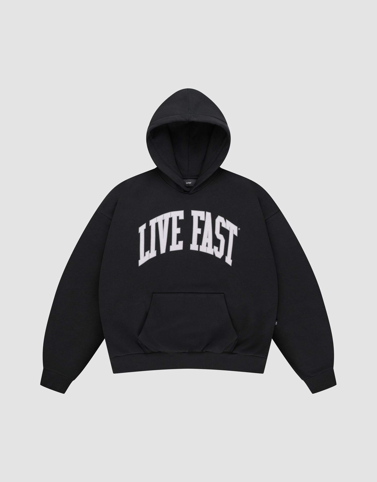 The LIVE FAST DIE YOUNG "Live Fast College Hooded" is a black, oversized cotton pullover featuring a front pocket and bold white “LIVE FAST” print across the chest. | plain