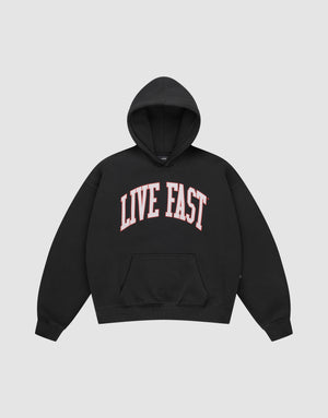 The Live Fast College Hooded by LIVE FAST DIE YOUNG is a black, oversized hoodie with a front pocket and striking pink and white LIVE FAST print on the chest, crafted from comfortable Baumwolle. | plain