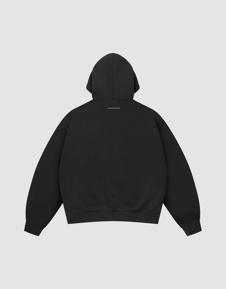 The LIVE FAST DIE YOUNG Live Fast College Hooded is an oversized black sweatshirt, shown from the back with a small white text logo below the hood, made from premium cotton against a plain light gray background.