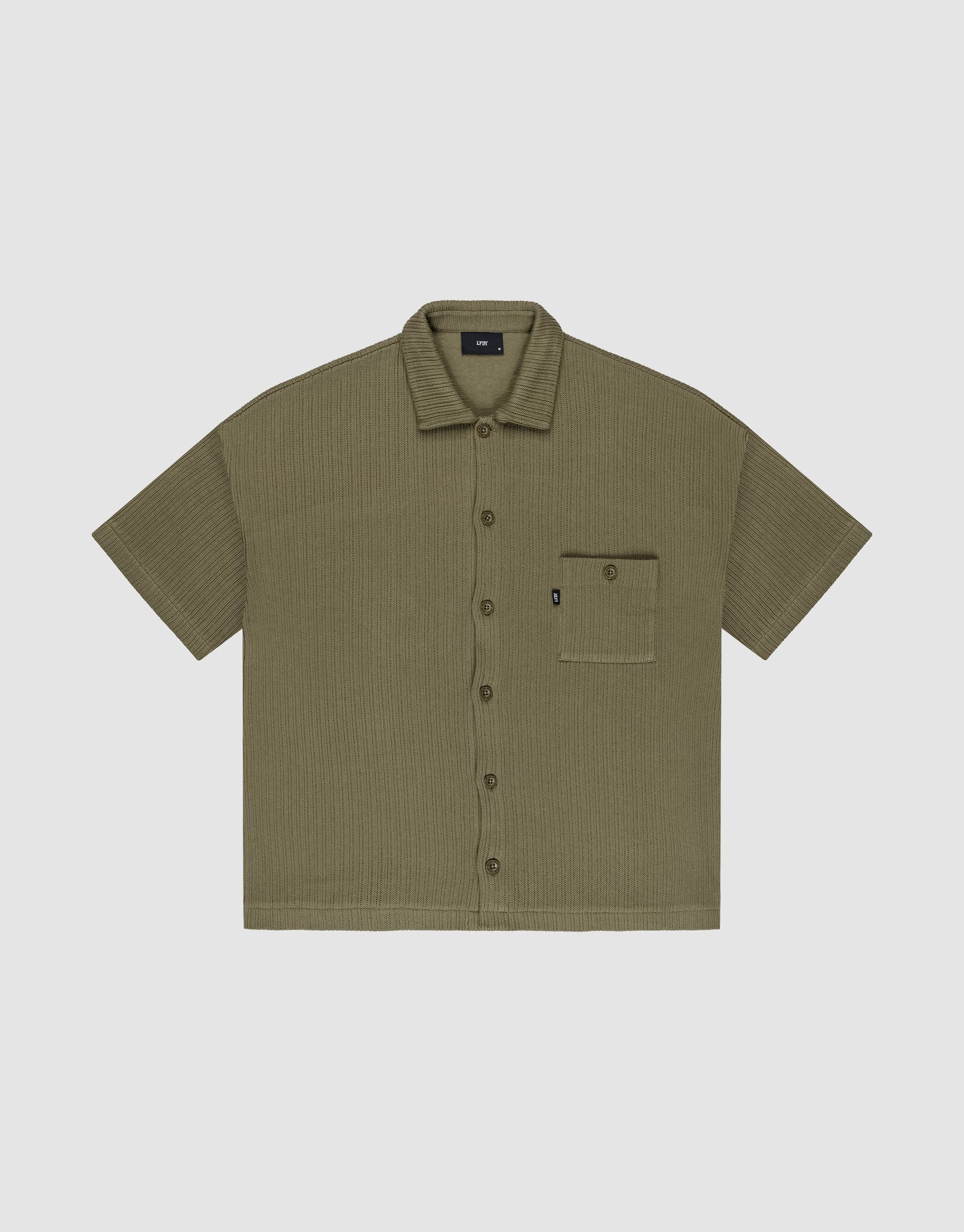 Olive green Basic Knit Shirt by LIVE FAST DIE YOUNG, oversize fit with short sleeves, textured fabric, and a single left chest pocket with a small black tag; shirt is laid flat on a light background. | plain