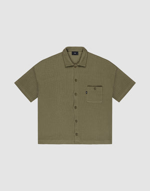 Olive green Basic Knit Shirt by LIVE FAST DIE YOUNG, oversize fit with short sleeves, textured fabric, and a single left chest pocket with a small black tag; shirt is laid flat on a light background. | plain