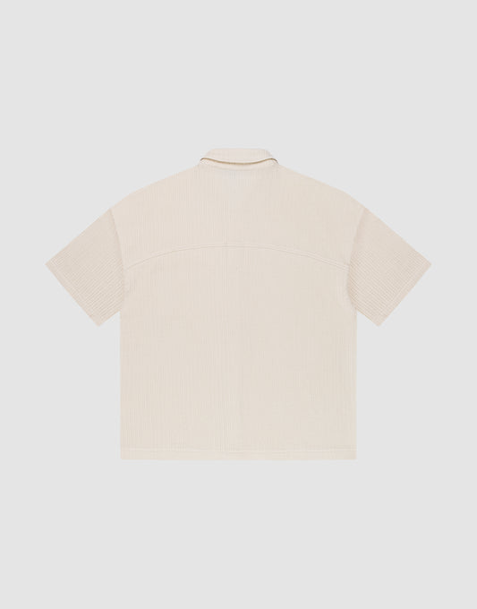 The LIVE FAST DIE YOUNG Basic Knit Shirt is a beige, oversized short-sleeve shirt with Hemdkragen, shown from the back and laid flat on a plain white background.