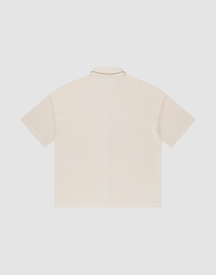 The LIVE FAST DIE YOUNG Basic Knit Shirt is a beige, oversized short-sleeve shirt with Hemdkragen, shown from the back and laid flat on a plain white background.