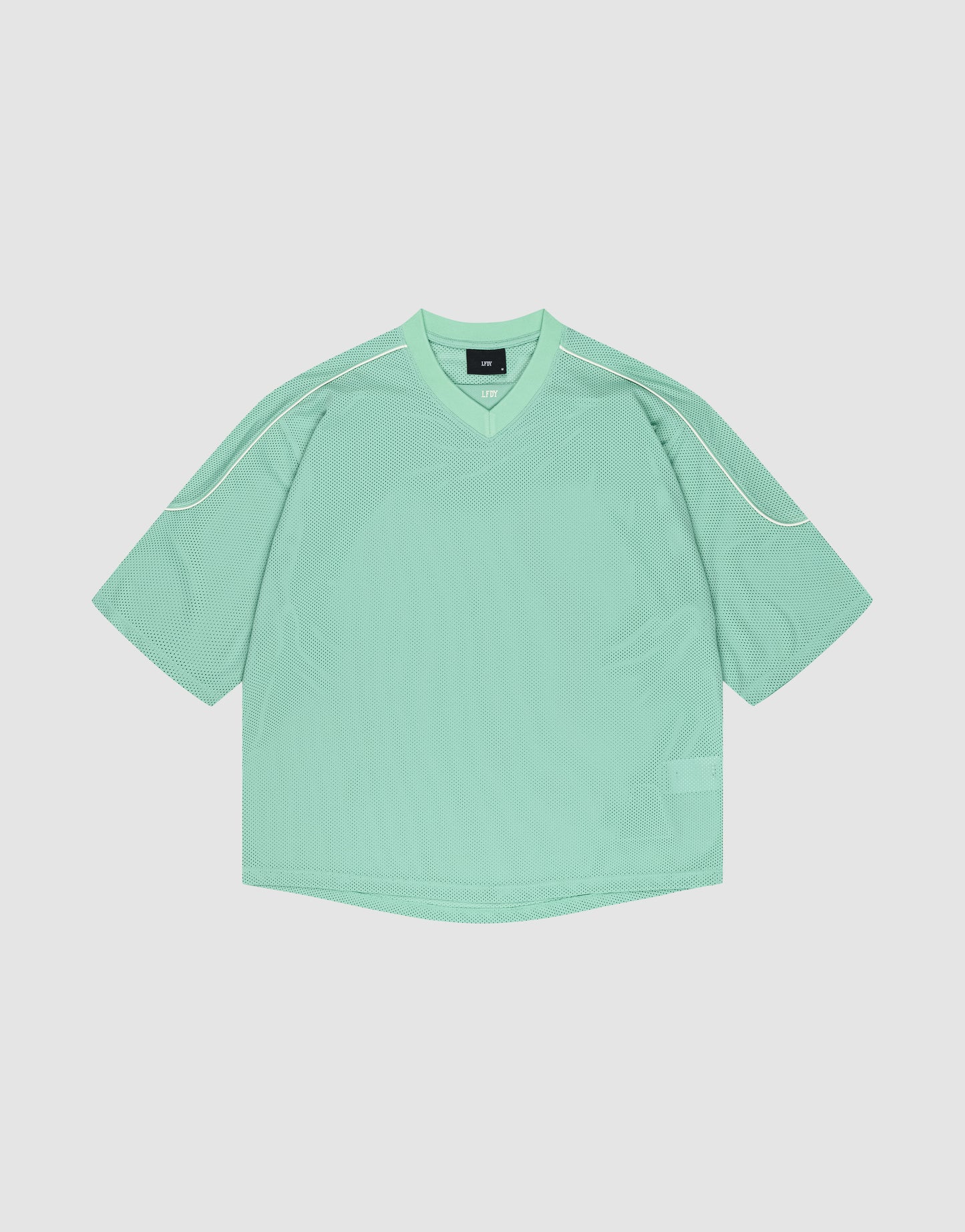 The LIVE FAST DIE YOUNG Basic Mesh Jersey is a loose-fitting mint green short-sleeve shirt with a V-neck and white piping on the shoulders, crafted from soft polyester and shown laid flat on a light background.
