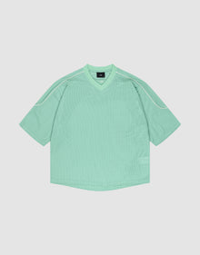 The LIVE FAST DIE YOUNG Basic Mesh Jersey is a loose-fitting mint green short-sleeve shirt with a V-neck and white piping on the shoulders, crafted from soft polyester and shown laid flat on a light background. | plain