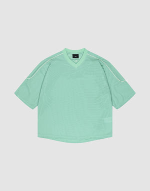 The LIVE FAST DIE YOUNG Basic Mesh Jersey is a loose-fitting mint green short-sleeve shirt with a V-neck and white piping on the shoulders, crafted from soft polyester and shown laid flat on a light background. | plain