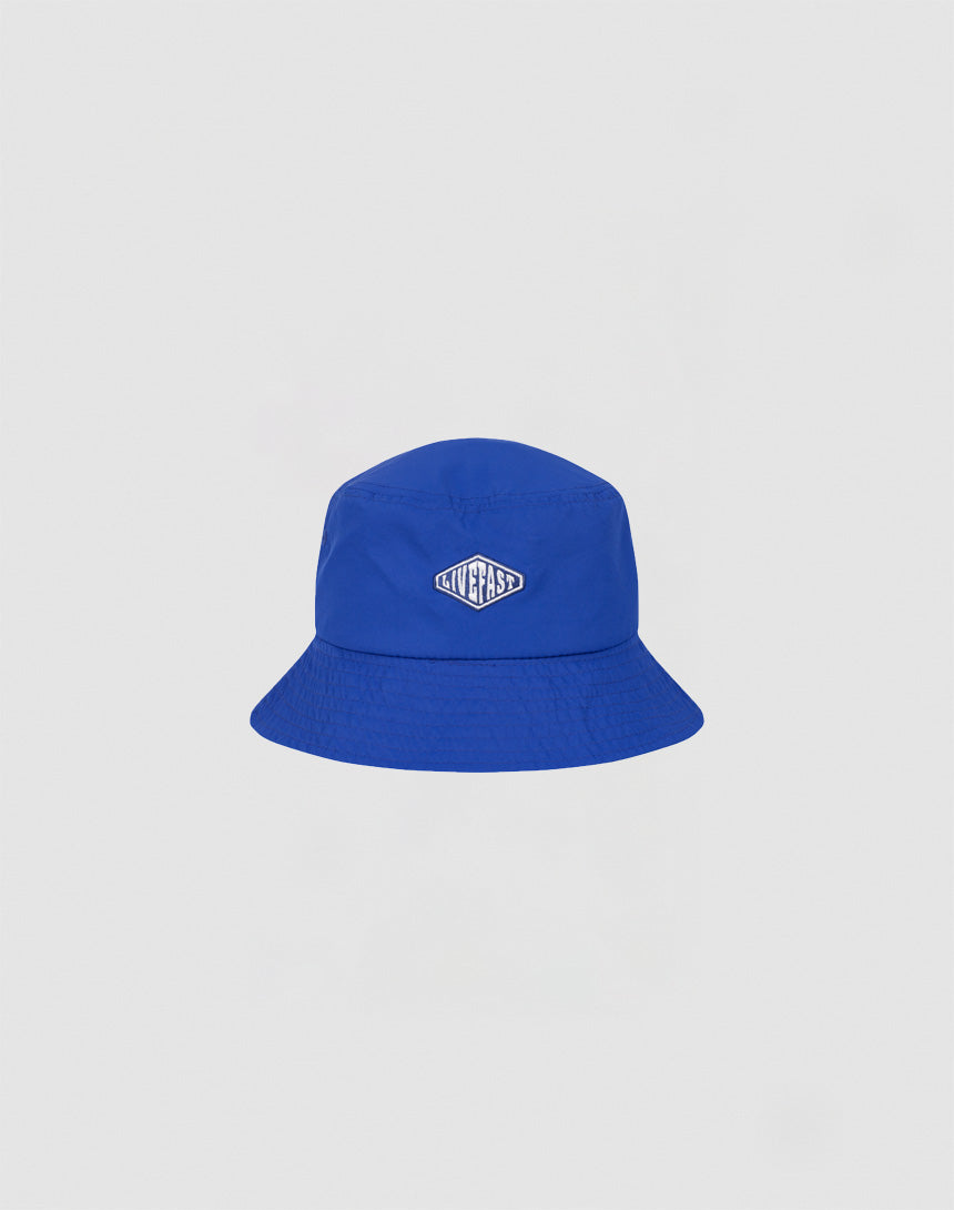 A bright blue Nylon Bucket Hat by LIVE FAST DIE YOUNG features a small oval Live Fast Logo-Stick patch on the front, shown against a plain white background.
