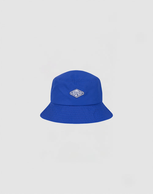 A bright blue Nylon Bucket Hat by LIVE FAST DIE YOUNG features a small oval Live Fast Logo-Stick patch on the front, shown against a plain white background.