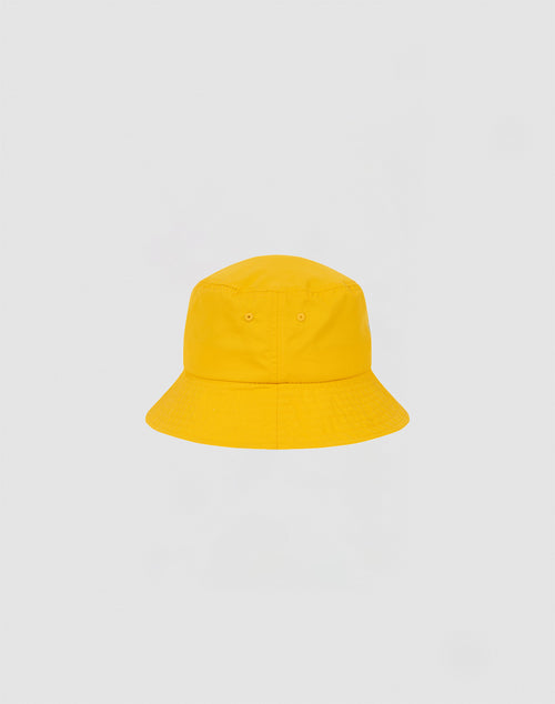 A bright yellow LIVE FAST DIE YOUNG Nylon Bucket Hat with a soft, rounded crown and downward-sloping brim is centered against a plain light gray background.