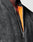 Close-up of a person wearing the LIVE FAST DIE YOUNG Washed Bomber Jacket in black, featuring a visible silver zipper, bright orange lining, and a subtle Live Fast Stickpatch for an edgy touch.