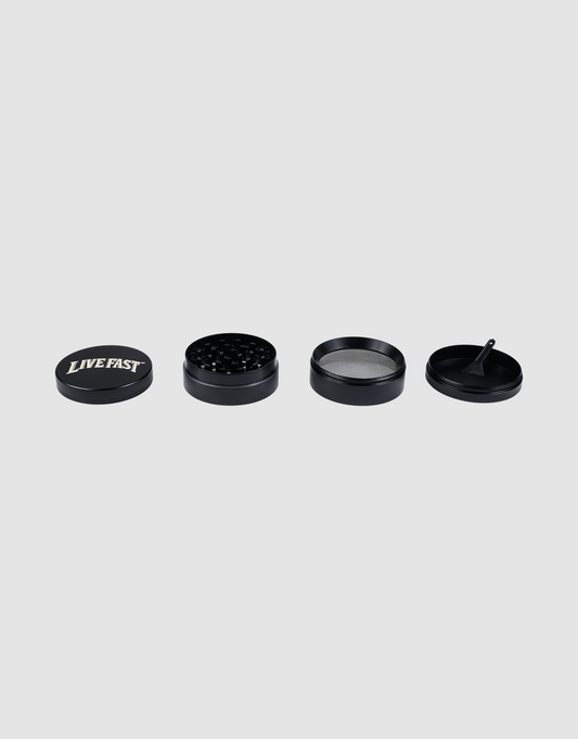Four 55 mm schwarz aluminum Live Fast Grinder parts from LIVE FAST DIE YOUNG are lined up on a light gray background. The first part’s lid displays the slogan LIVE FAST in bold white text.