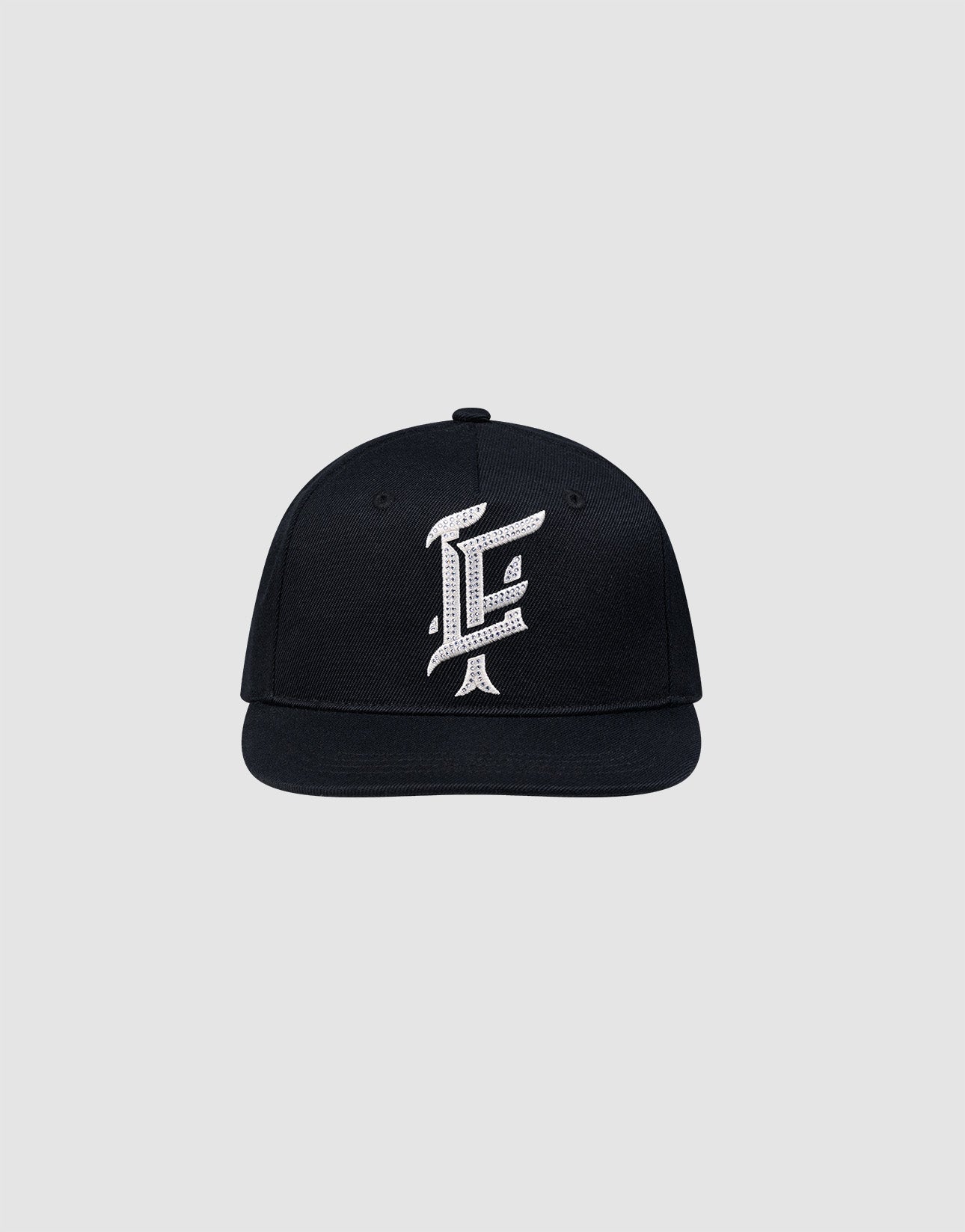 The LF Rhinestone Cap by LIVE FAST DIE YOUNG features a black cotton design with a bold white embroidered letter F on the front, showcased against a plain light gray background.