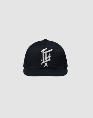 The LF Rhinestone Cap by LIVE FAST DIE YOUNG features a black cotton design with a bold white embroidered letter F on the front, showcased against a plain light gray background.
