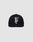 The LF Rhinestone Cap by LIVE FAST DIE YOUNG features a black cotton design with a bold white embroidered letter F on the front, showcased against a plain light gray background.