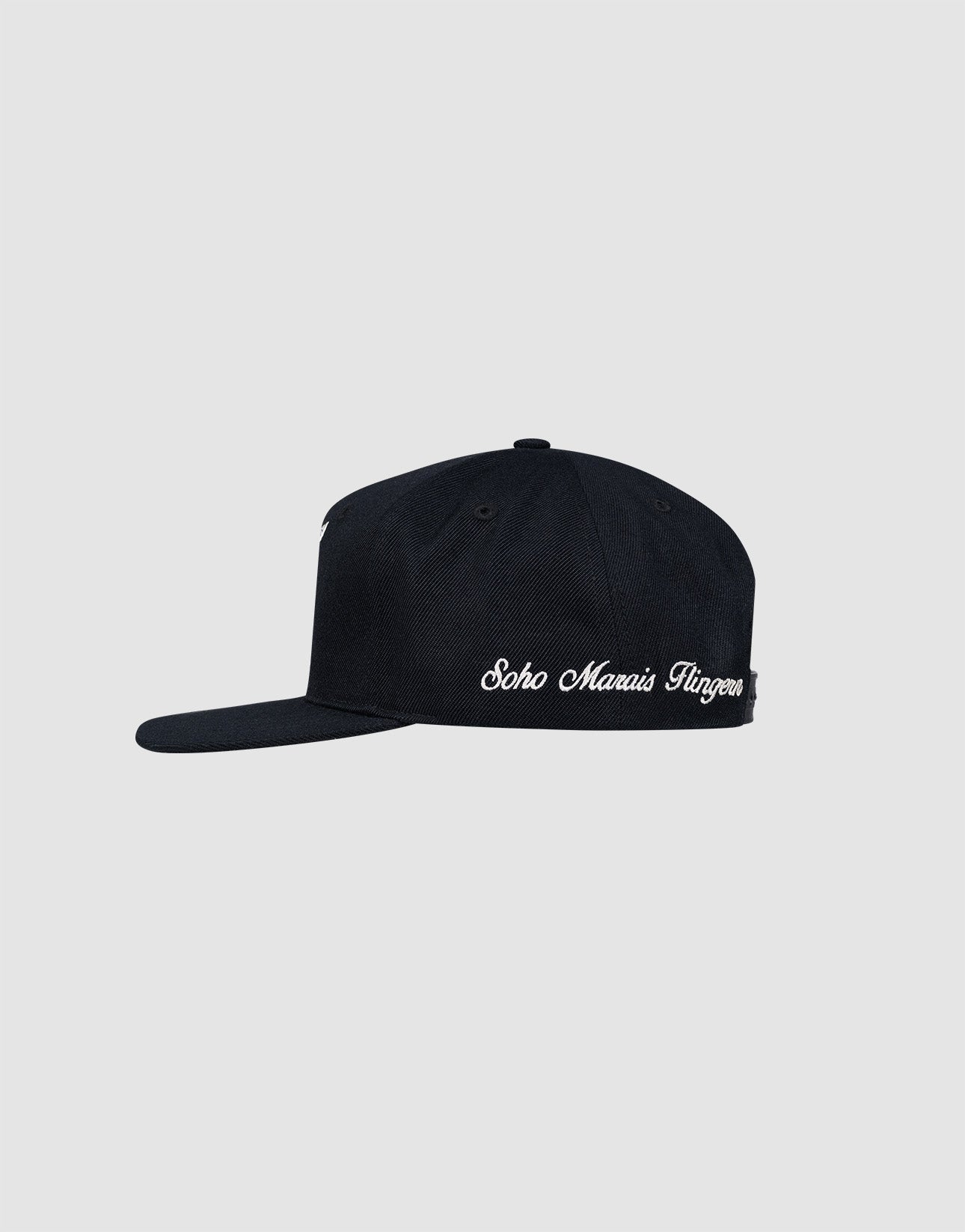 A black LF Rhinestone Cap by LIVE FAST DIE YOUNG, shown from the side, features white rhinestone text accents on the brim and crown, set against a plain light gray background.