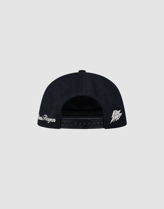 A black LF Rhinestone Cap by LIVE FAST DIE YOUNG is shown from the back, with white Logo-Stick text on the left side and a white graphic logo on the right, set against a plain light gray background.