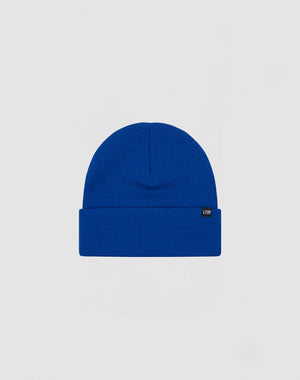 The LIVE FAST DIE YOUNG Basic Beanie is a plain royal blue polyacryl hat with a folded brim and a small black side flag label with white text, shown on a light gray background.