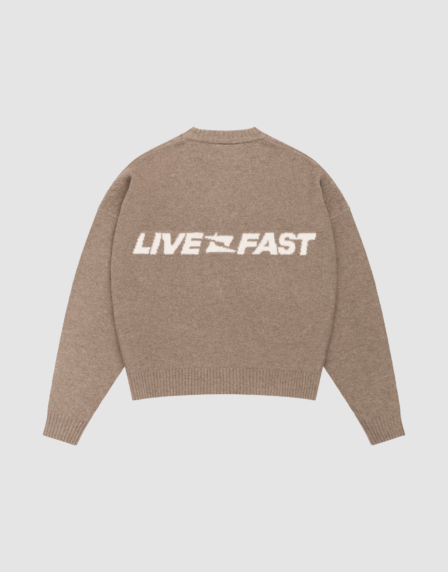 The Live Fast Boucle Sweater by LIVE FAST DIE YOUNG is an oversized beige knit with "LIVE FAST" in bold white letters and a small white flag icon on the back.