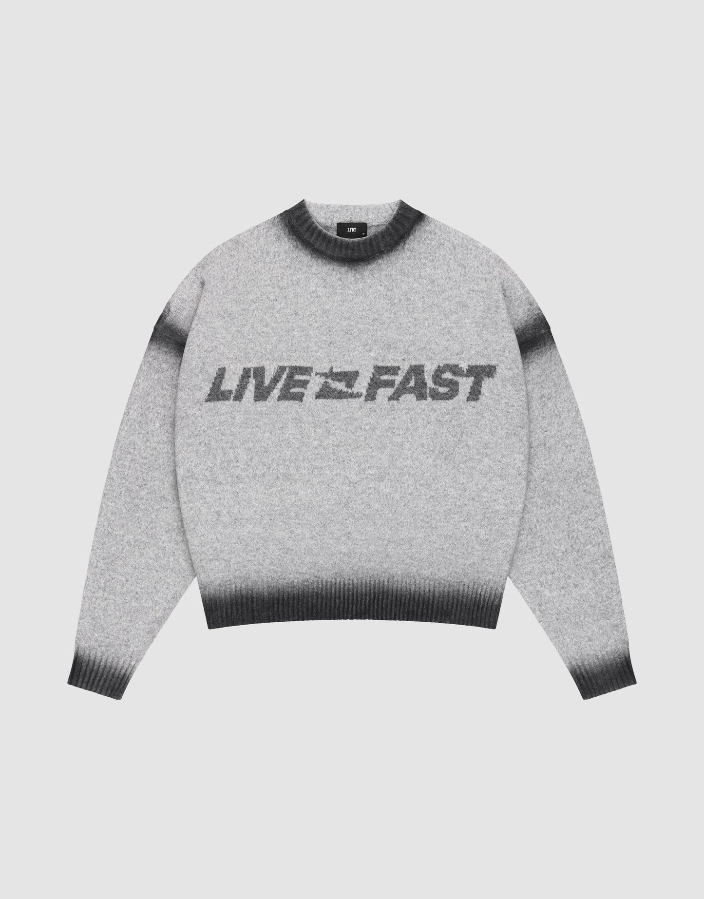 The Live Fast Boucle Sweater by LIVE FAST DIE YOUNG features a gray design with black cuffs, collar, and hem, bold “LIVE FAST” lettering across the front, and an oversize fit for a relaxed look.