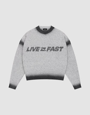 The Live Fast Boucle Sweater by LIVE FAST DIE YOUNG features a gray design with black cuffs, collar, and hem, bold “LIVE FAST” lettering across the front, and an oversize fit for a relaxed look. | plain