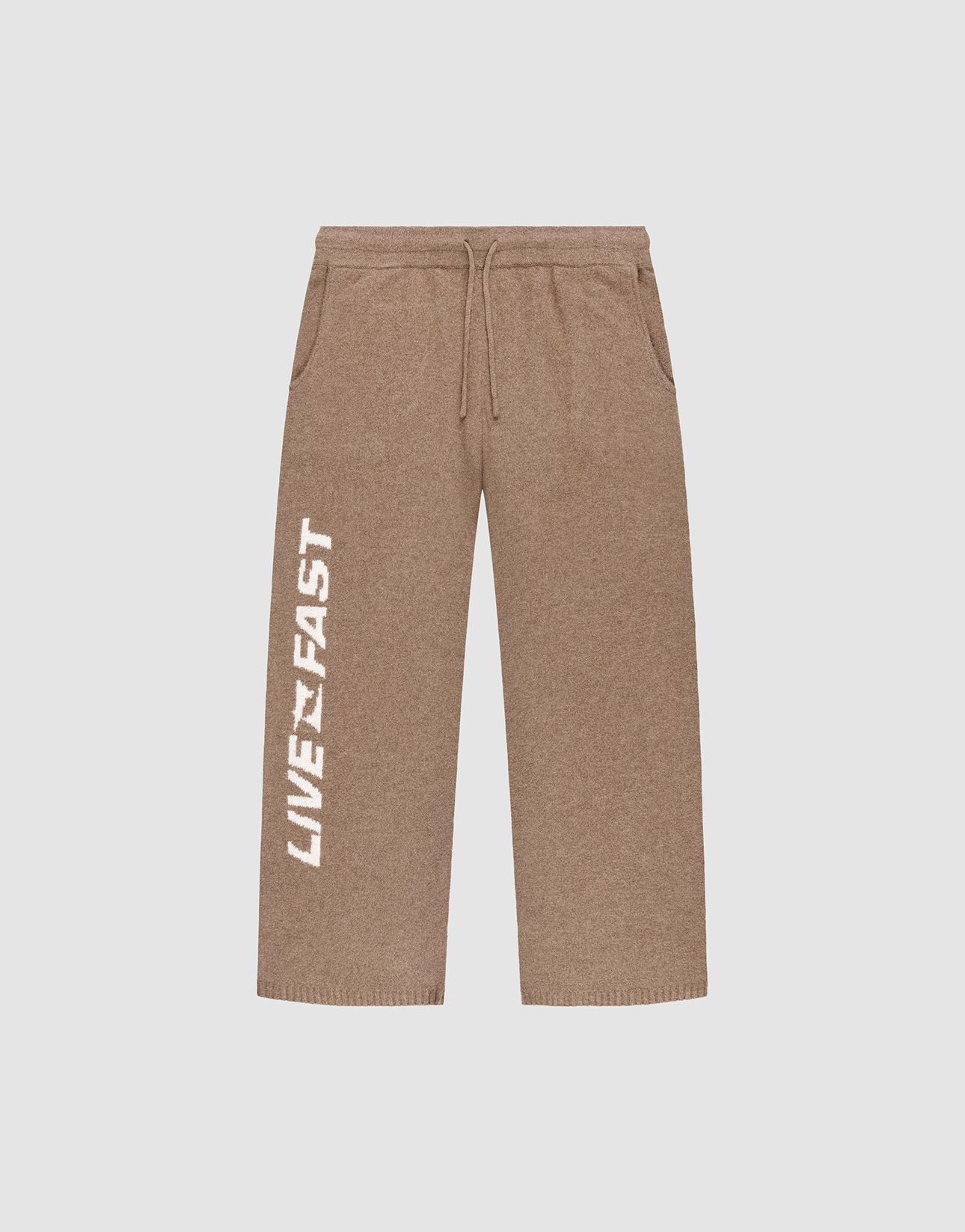 The Live Fast Boucle Pants by LIVE FAST DIE YOUNG are brown wide-leg sweatpants featuring a drawstring Elasticbund, side pockets, straight leg, and bold white "LIVE FAST" lettering printed vertically along the left leg.
