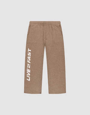 The Live Fast Boucle Pants by LIVE FAST DIE YOUNG are brown wide-leg sweatpants featuring a drawstring Elasticbund, side pockets, straight leg, and bold white "LIVE FAST" lettering printed vertically along the left leg. | plain